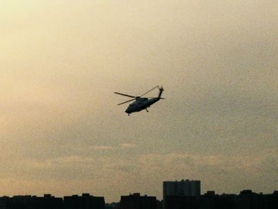 a helicopter flying in the sky over a city