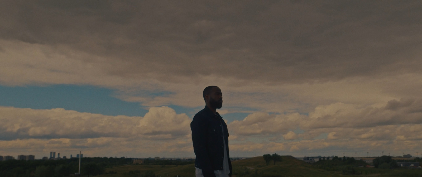 a man standing on top of a lush green field