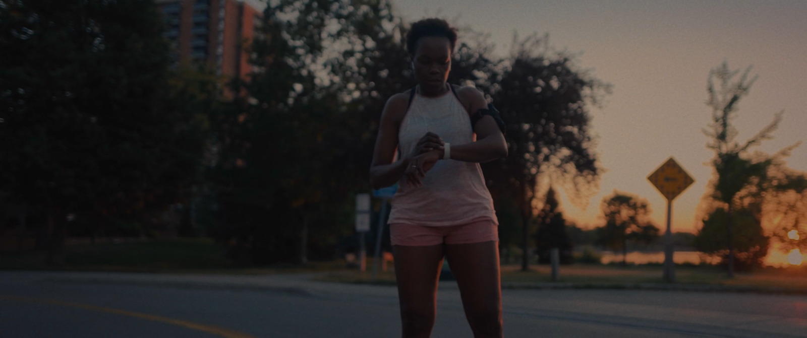 a woman riding a skateboard down a street