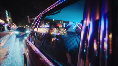 a car driving down a city street at night