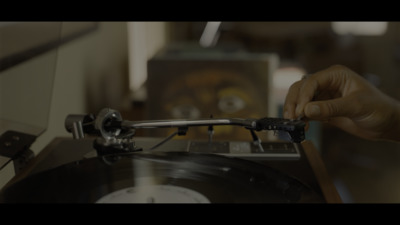 a person is pressing a record on a turntable