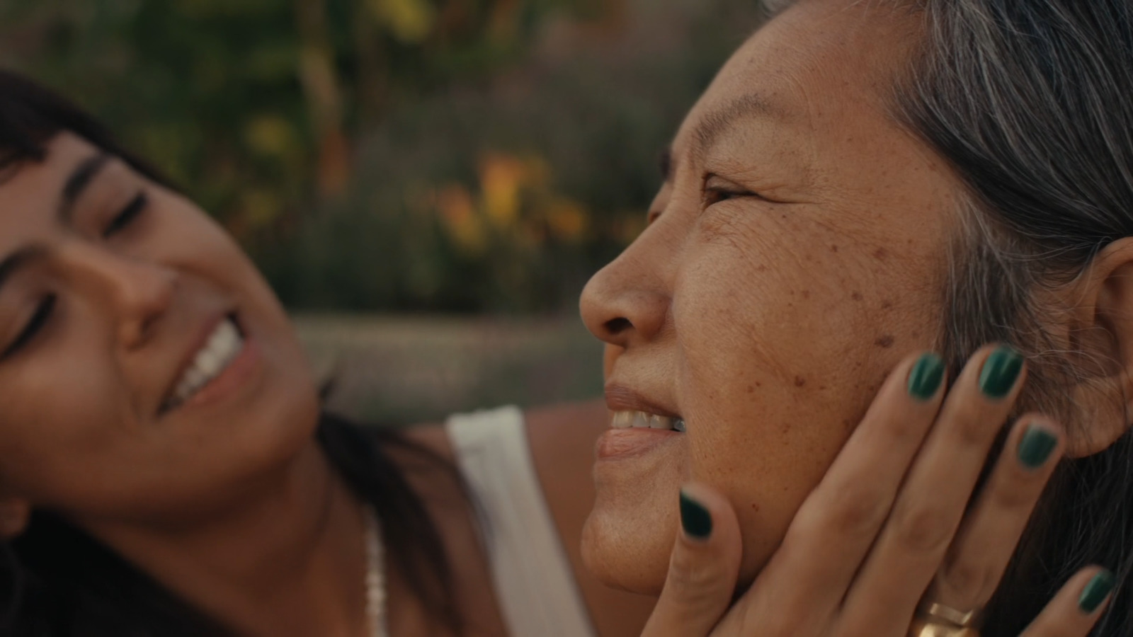 a close up of a woman talking on a cell phone