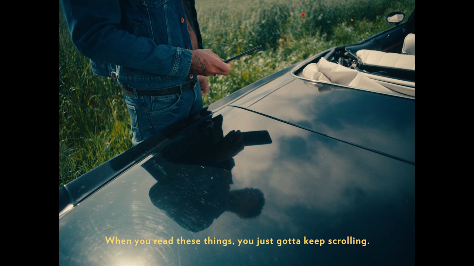 a man standing next to a parked car