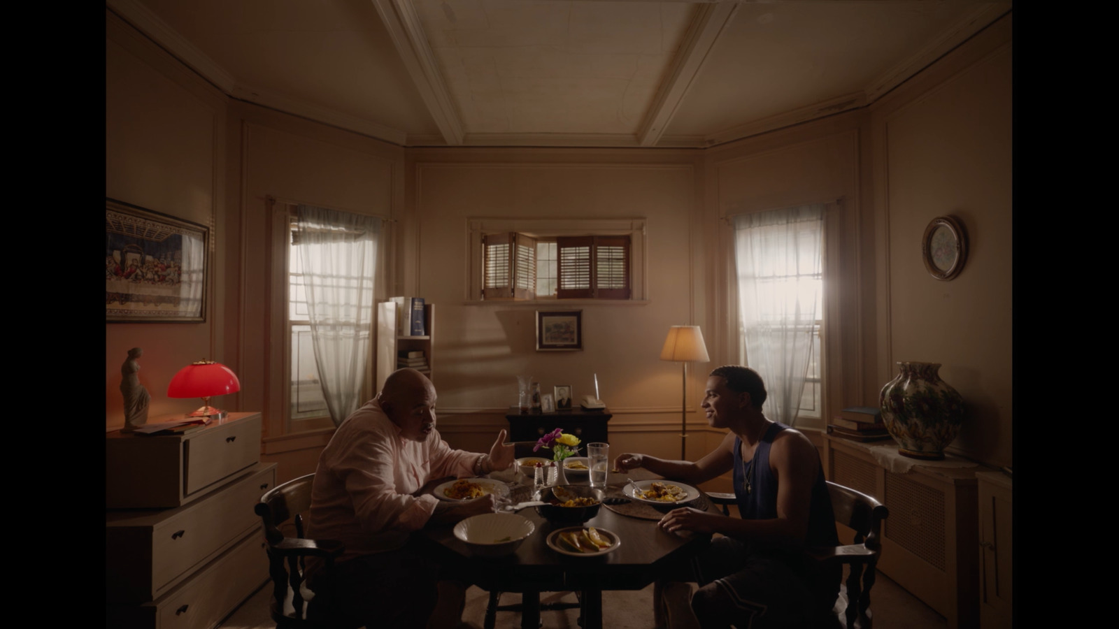 a couple of people sitting at a table eating food