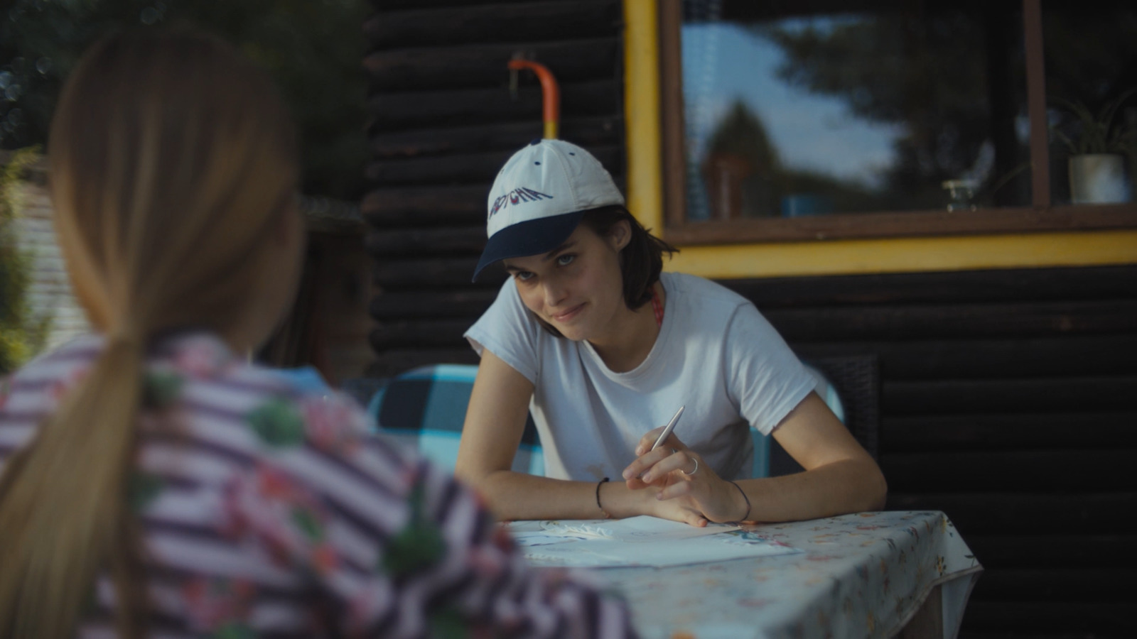 a young man sitting at a table with a woman