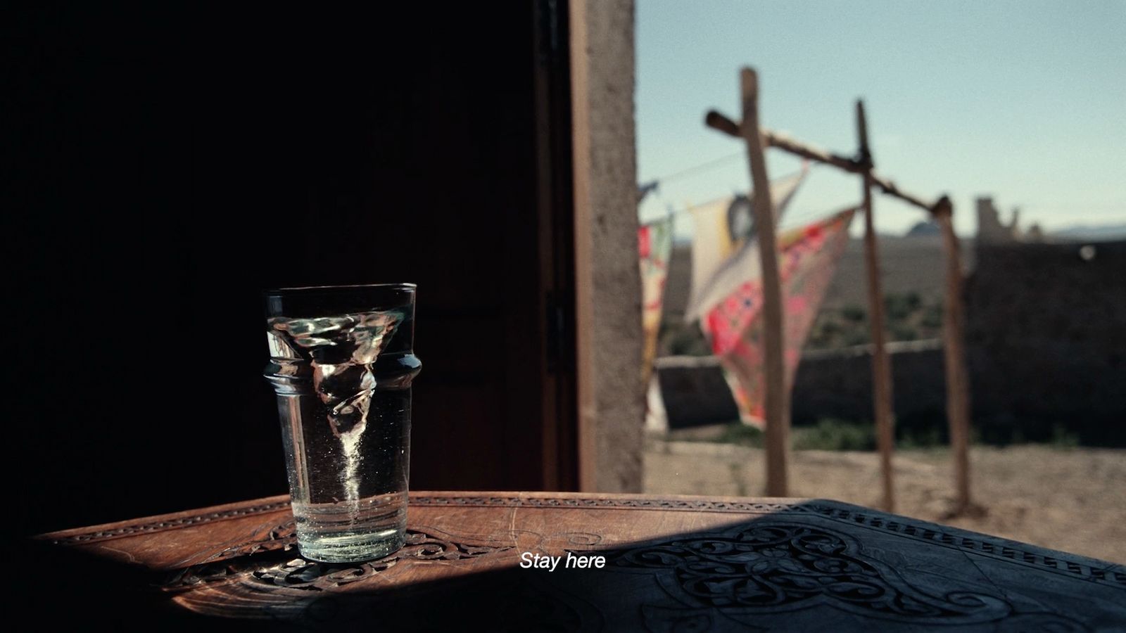 a glass of water sitting on top of a table