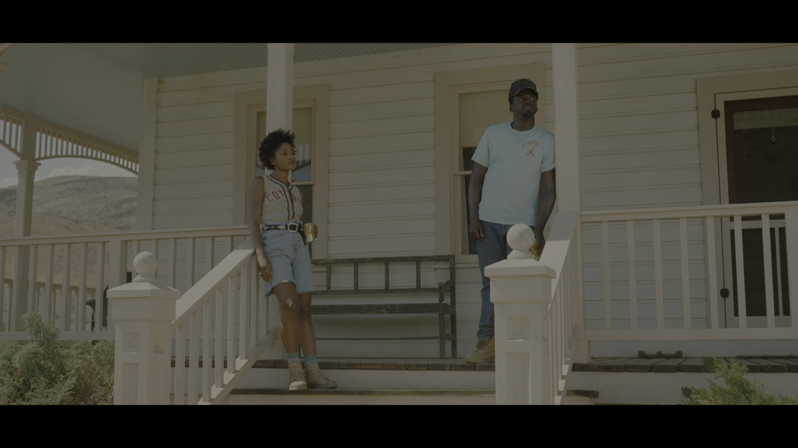 a man and a little girl standing on a porch