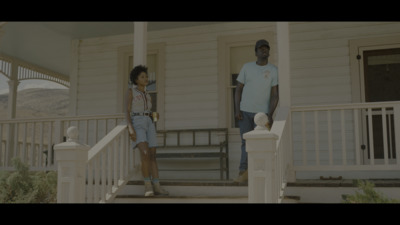 a man and a little girl standing on a porch