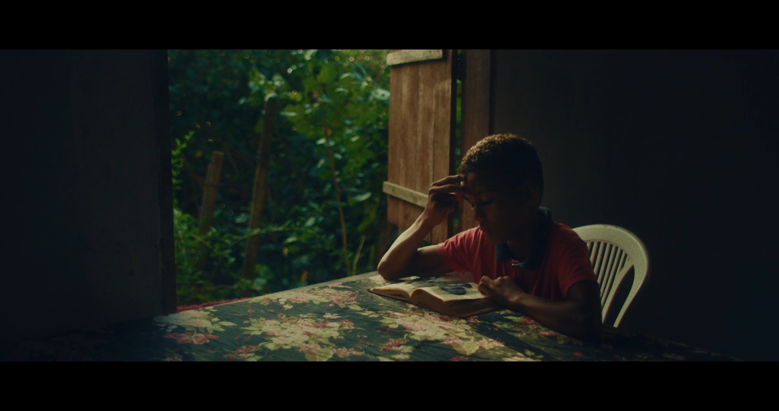 a person sitting at a table with a book