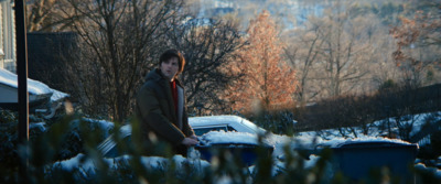 a man standing in front of a pile of snow