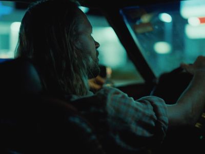 a man driving a car in the dark