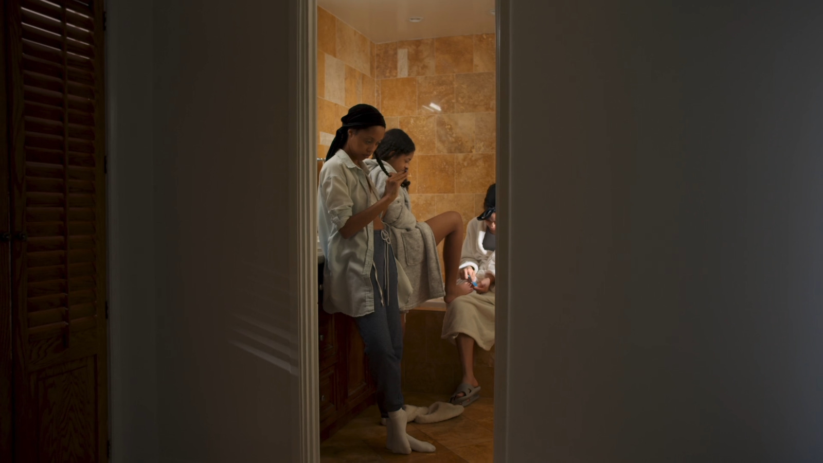 a couple of women standing in a bathroom next to each other