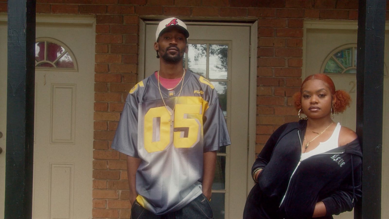 a man and a woman standing in front of a door