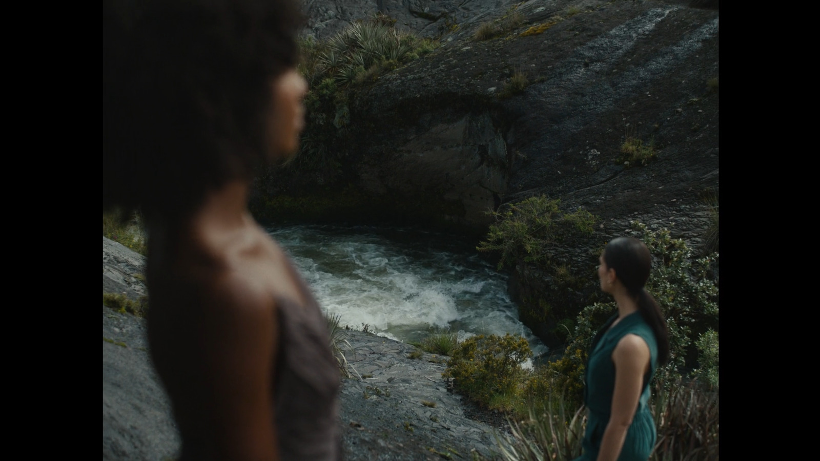 a woman standing in front of a river