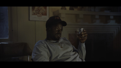 a man sitting in a chair holding a glass