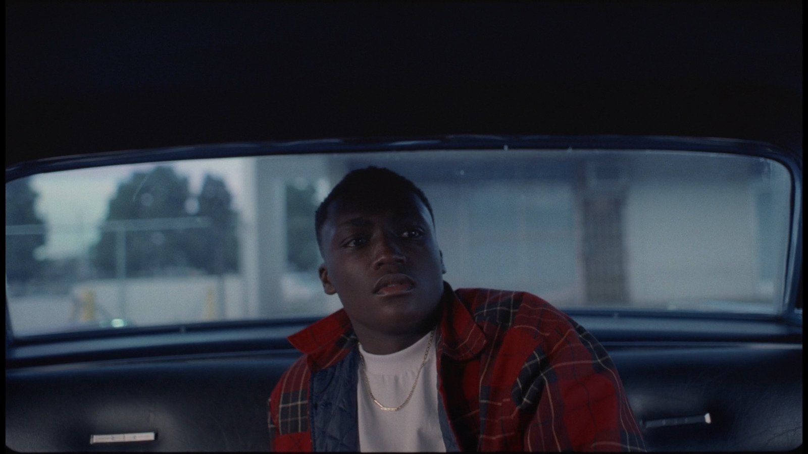 a man sitting in the back of a car