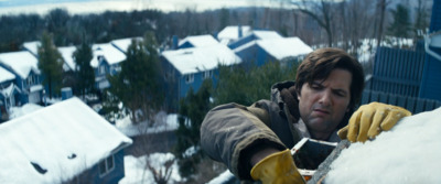 a man in yellow gloves working on a roof