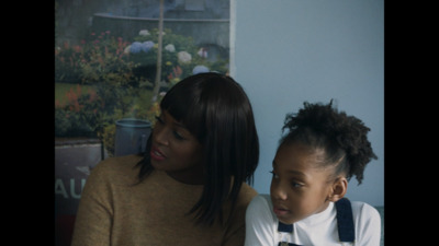 a woman and a young girl sitting next to each other