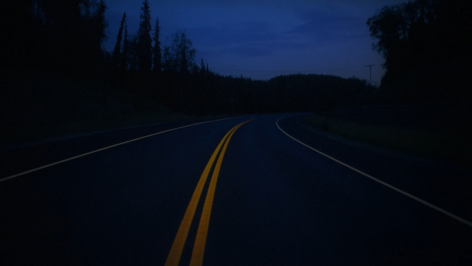 a road with yellow lines in the middle of it