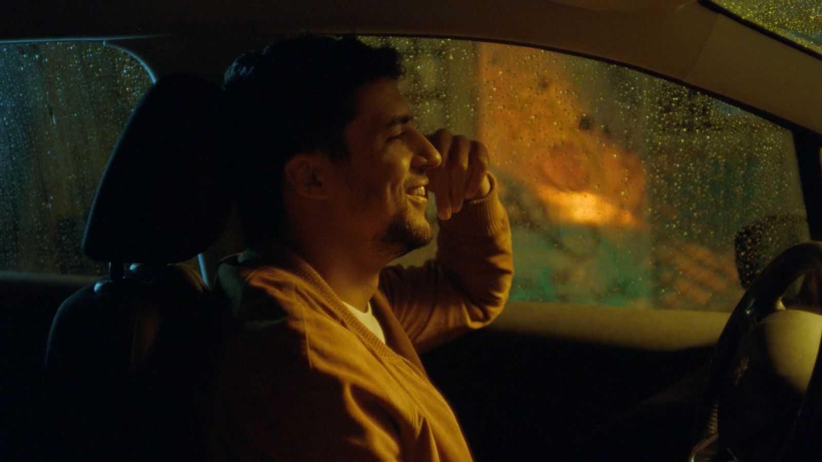 a man sitting in the passenger seat of a car