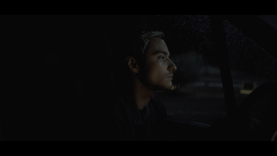 a man sitting in a car in the rain