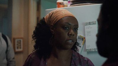 a woman standing in front of a refrigerator in a kitchen