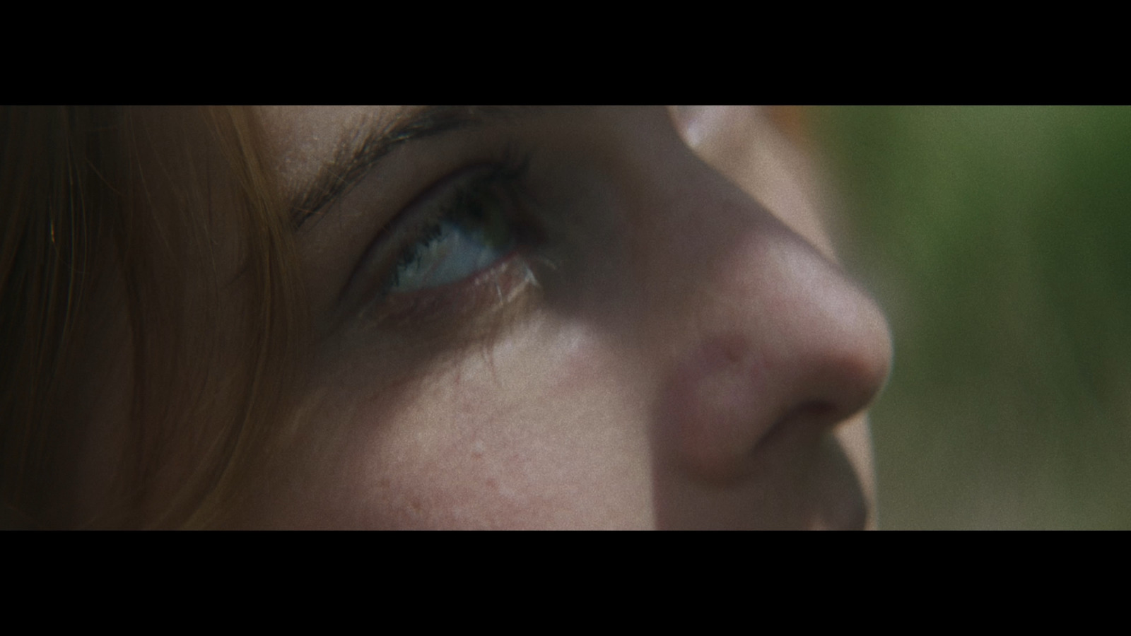 a close up of a person's face with a blurry background