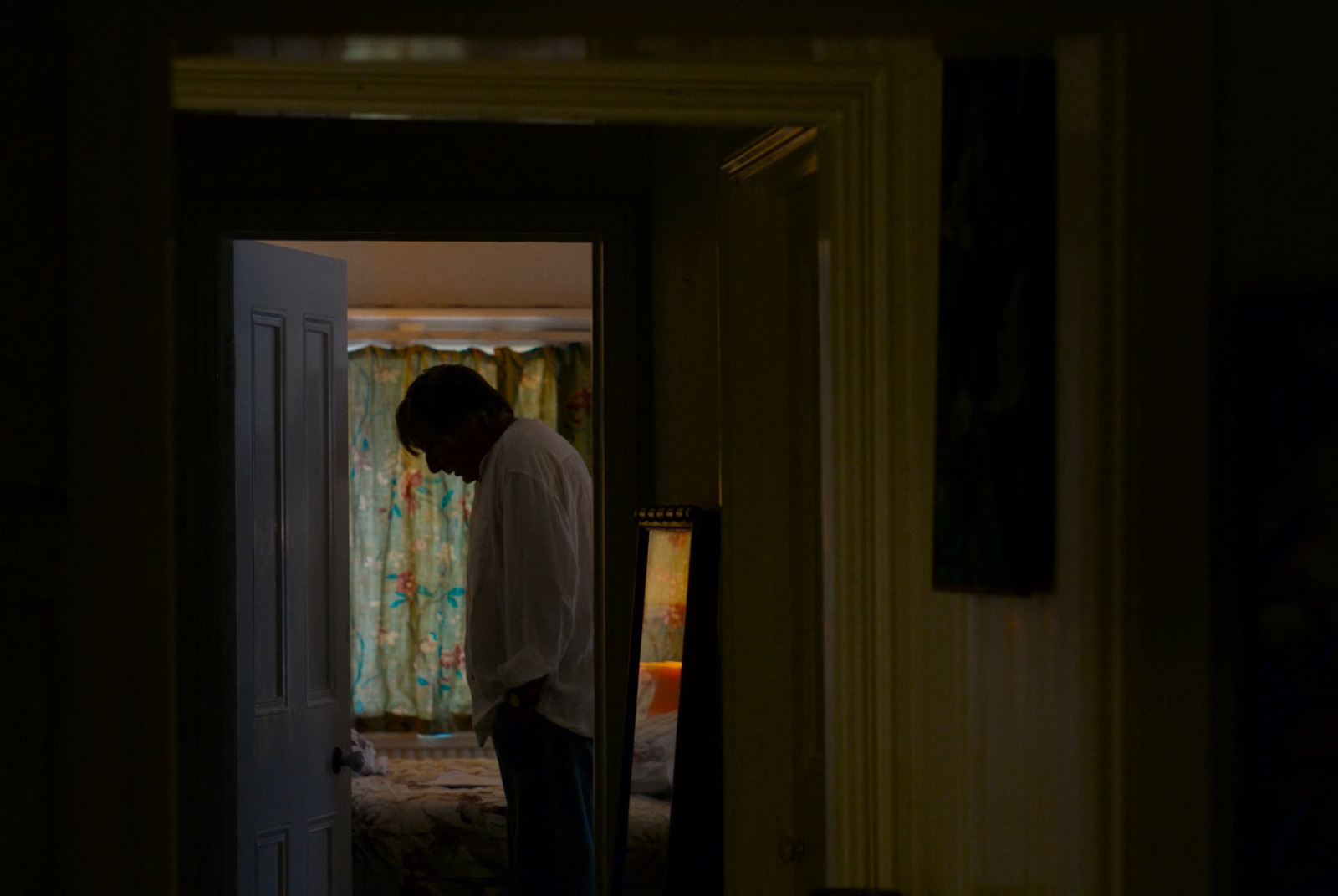 a man standing in a doorway of a house