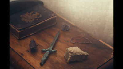 a sword and a rock on a table