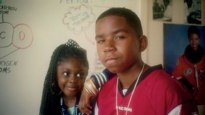 a boy and a girl posing for a picture