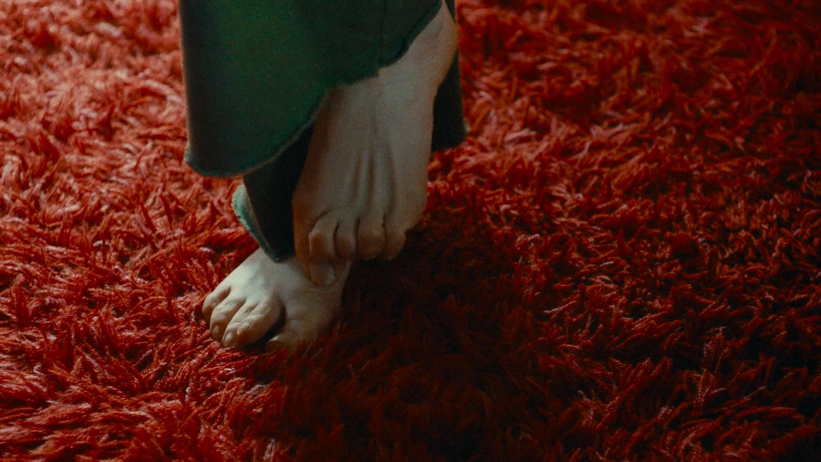 a close up of a person's foot on a red carpet