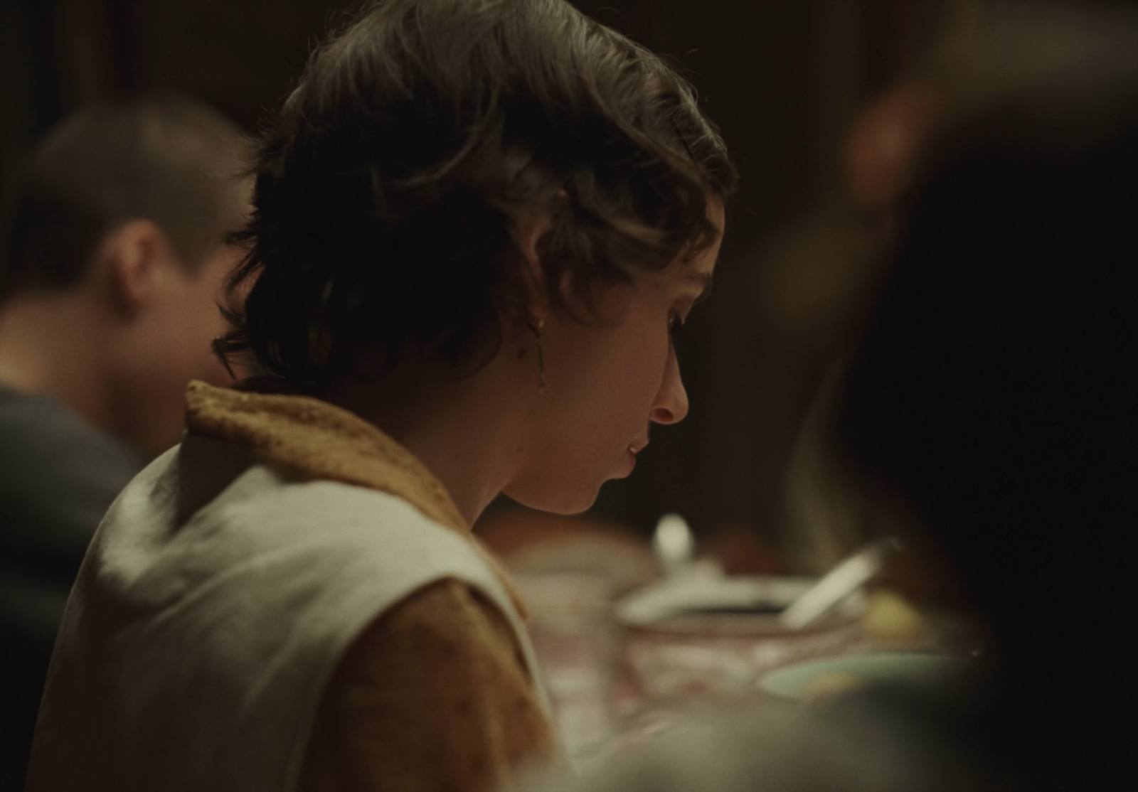 a woman sitting at a table with a plate of food