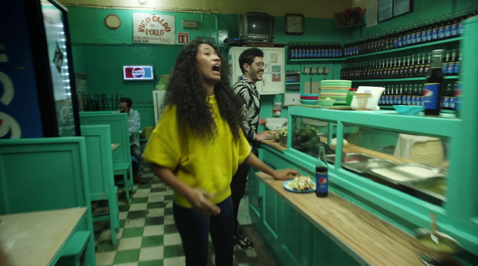 a woman standing in front of a counter in a restaurant