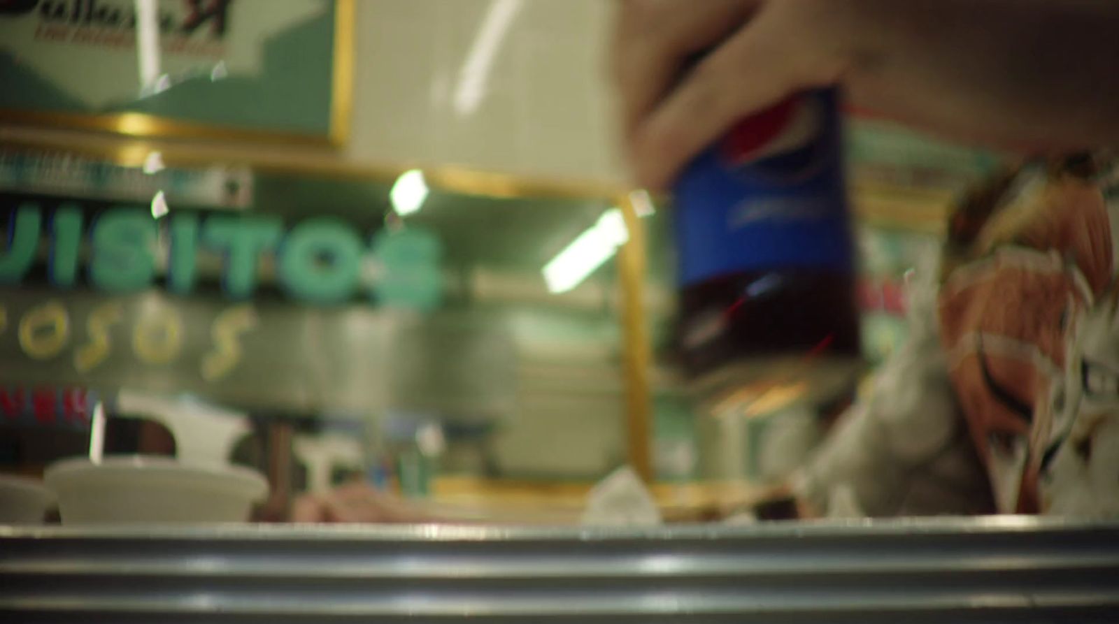 a close up of a person pouring something into a cup