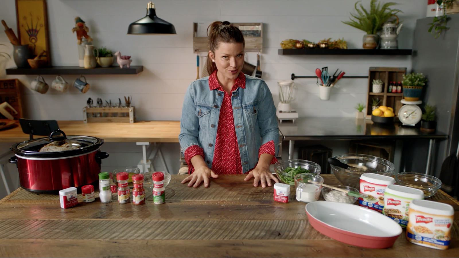 a woman standing in front of a table filled with food