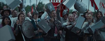 a crowd of people holding up signs and flags