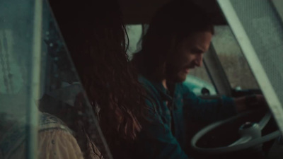 a man driving a car in the rain