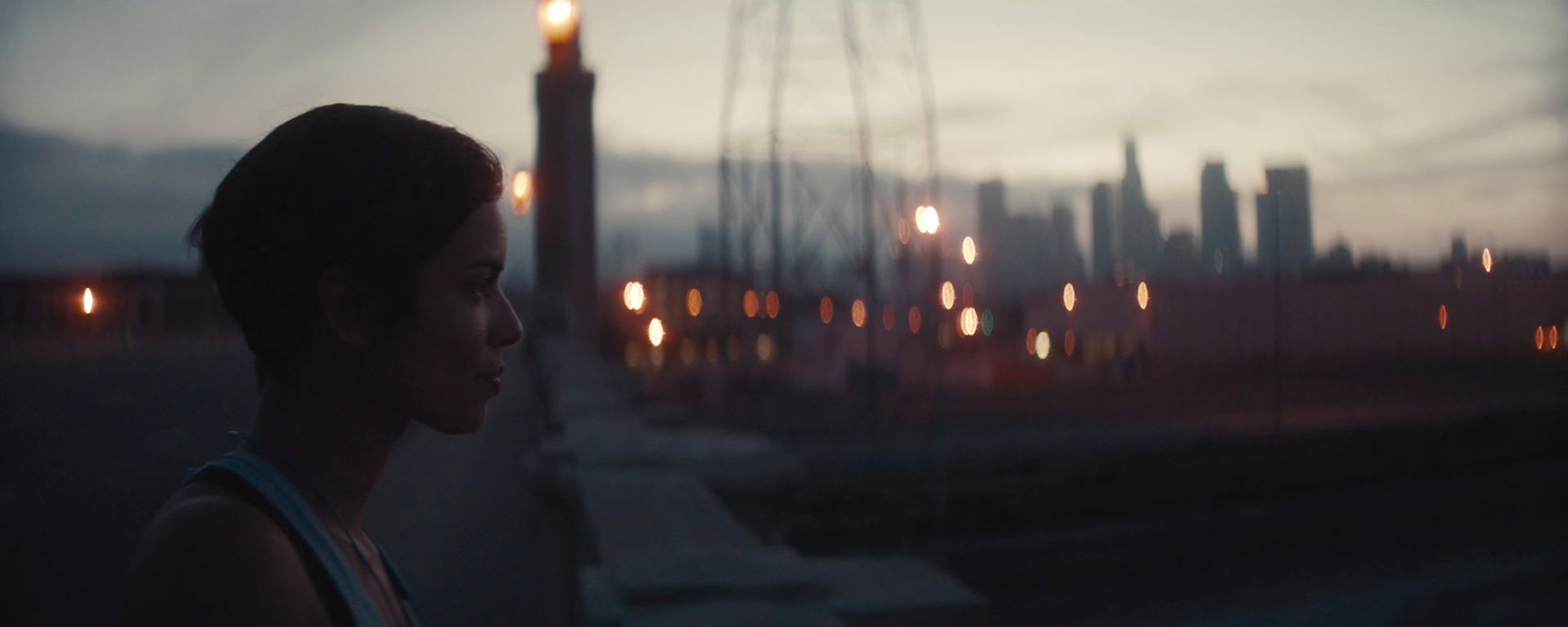 a woman looking out a window at a city