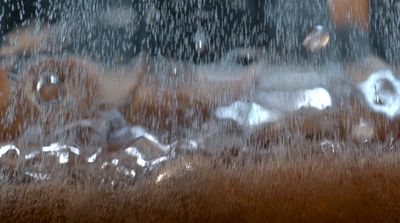 a close up of a window with rain falling on it