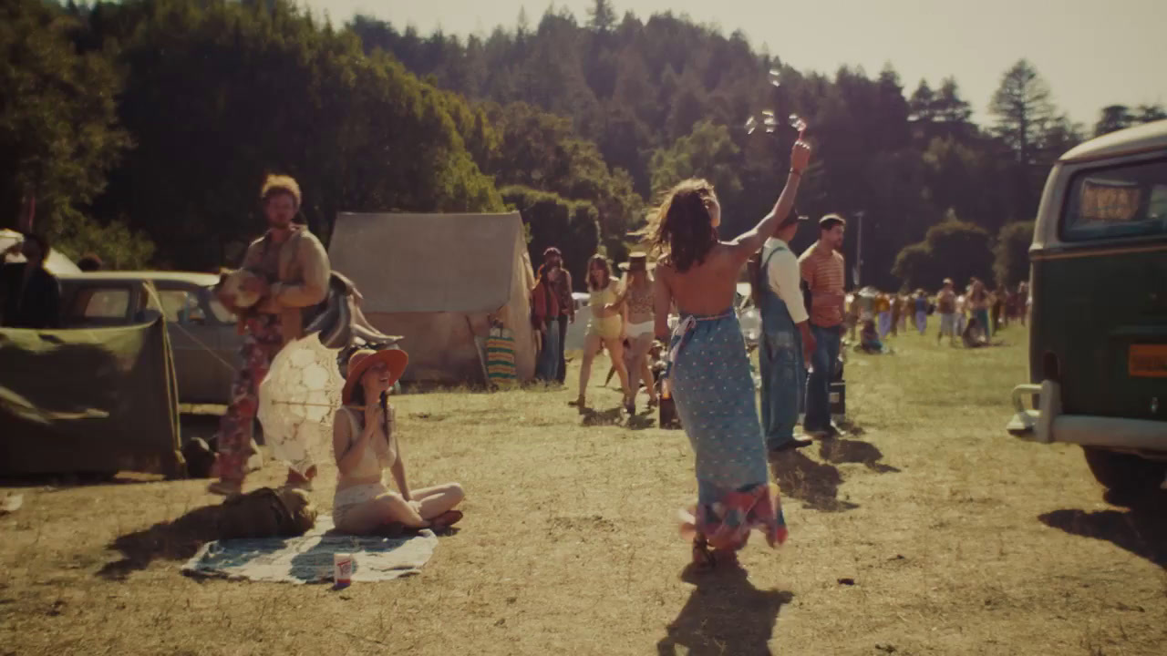 a group of people standing around in a field