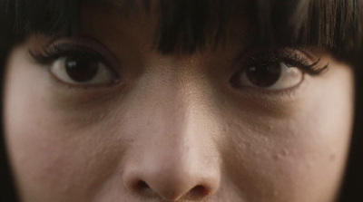 a close up of a woman's face with bangs