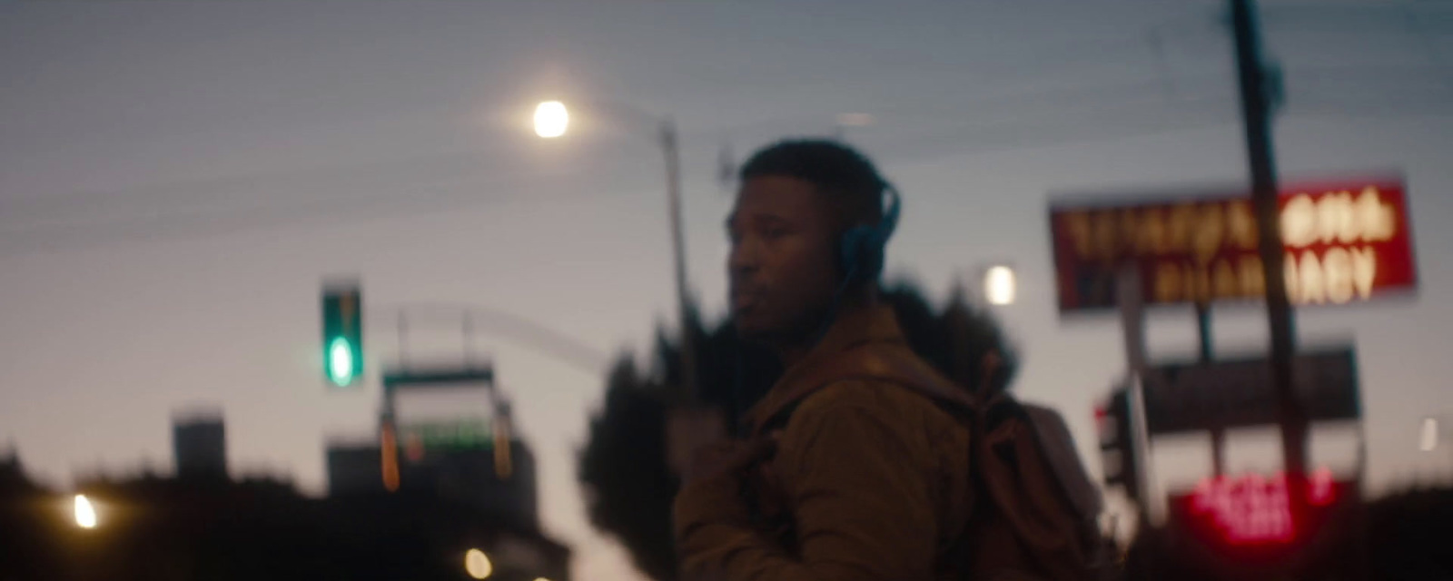 a man walking down a street at night