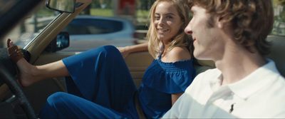 a man and a woman sitting in a car