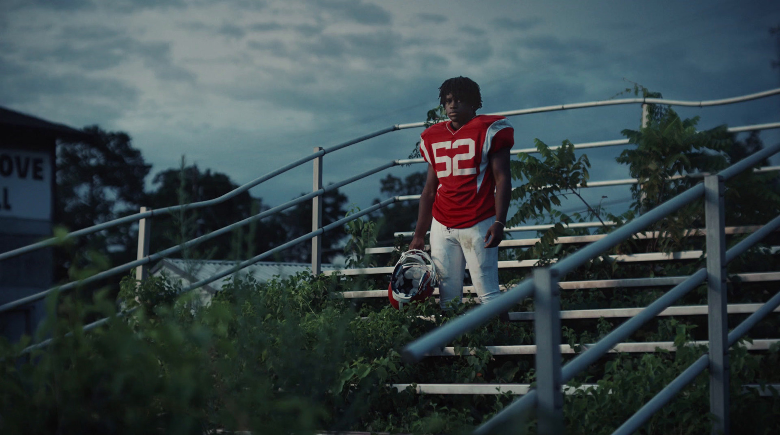 a man in a football uniform walking up some stairs