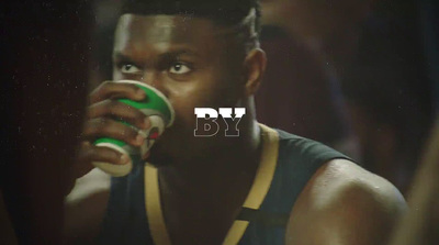 a man drinking from a green and white cup