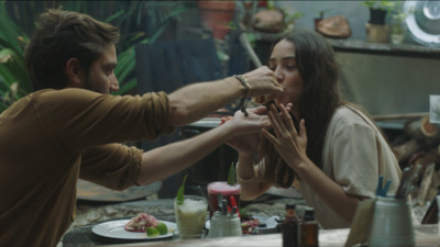 a man feeding a woman a piece of cake