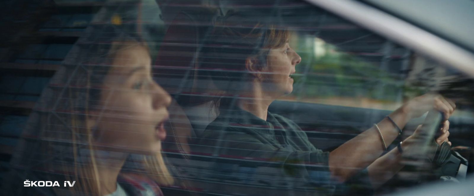 a man and a woman sitting in a car