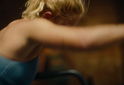 a blurry photo of a woman in a sports bra