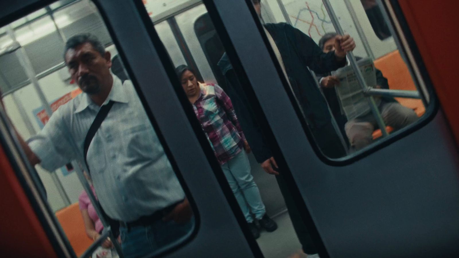 a group of people standing on a subway train