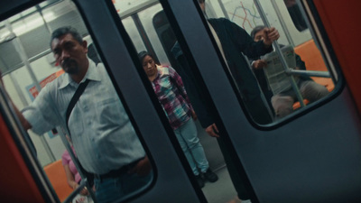 a group of people standing on a subway train